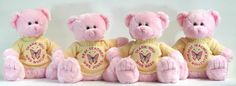 three pink teddy bears sitting next to each other