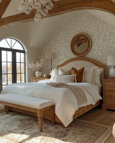 a large bed sitting in a bedroom on top of a wooden floor next to a window