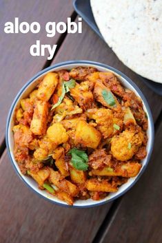 aloo gobi dry in a bowl with tortilla on the side