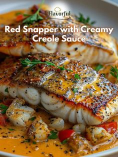 red snapper with creamy cremee sauce on a white plate topped with scallops