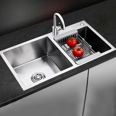 a kitchen sink with two tomatoes in it