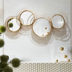 the wall is decorated with metal circles and balls, as well as other decorative objects