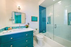 a bathroom with blue and white tiles on the walls