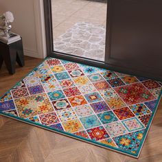 a multicolored area rug with an open door