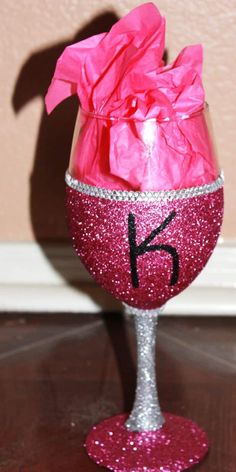 a wine glass with pink tissue paper wrapped around the top and number 15 on it