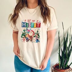 a woman standing next to a potted plant wearing a pirate's life t - shirt