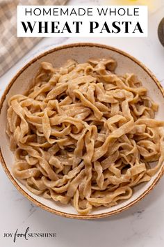 homemade whole wheat pasta in a bowl with text overlay that reads homemade whole wheat pasta