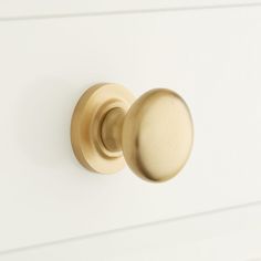 a close up of a door knob on a white cabinet