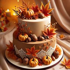 a three tiered cake decorated with fall leaves and acorns