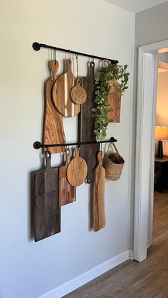 several wooden cutting boards hanging on a wall