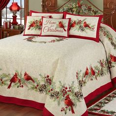 a christmas themed bed with red and white comforter, pillows and pillowcases