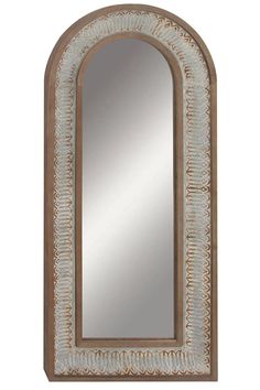 an arched mirror on a white wall