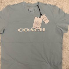 Small Women’s Coach Shirt In Light Blue. Purchased From The Coach Store, Brand New With Tags. Pet Free And Smoke Free Home Coach Clothing, Coach Tshirts, Coach Shirt, Coach Store, Coach Shirts, Coach Logo, Small Women, Dressing Room, Shirt Outfit