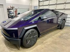 a futuristic car is parked in a garage