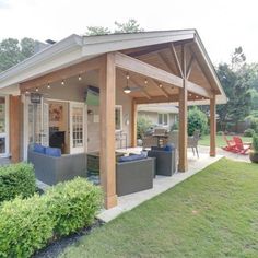 a covered patio area with furniture and lights