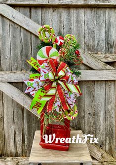 a candy cane christmas wreath on top of a red box