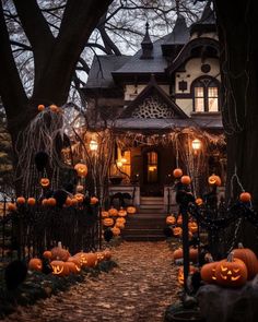 a house decorated for halloween with pumpkins and lights