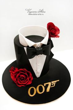 a black hat with a white shirt and red rose on top that says 700th birthday