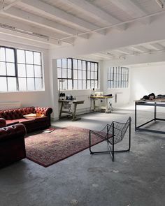 an empty room with couches, tables and other items in the area around them