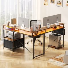 an office desk with two computers on it in front of a large window and wooden floors