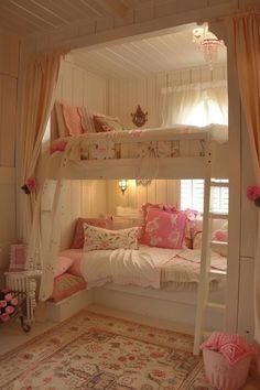 a white bunk bed sitting next to a pink rug on top of a wooden floor