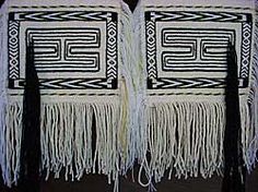 two black and white bags with fringes on them