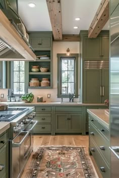 a kitchen with green cabinets and an area rug