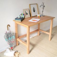 a wooden table with an umbrella and pictures on it