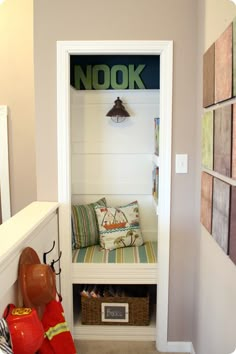 an entry way with a bench and fireman's hat on the shelf next to it