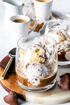 two glasses filled with ice cream on top of a plate