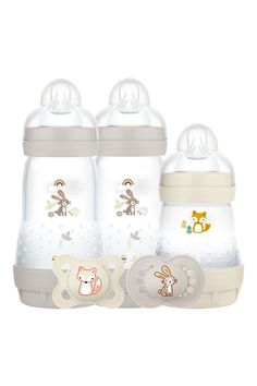 three baby bottles with their lids open and one in the shape of an animal on it