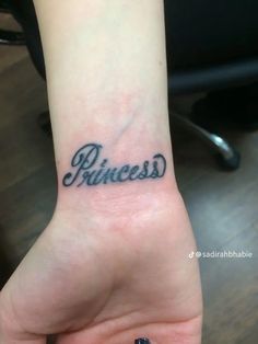 a small wrist tattoo with the word princess on it