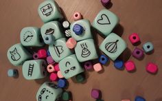 many different colored dices on a table with hearts and other items around them,