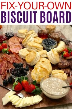 a wooden board topped with lots of different types of food and desserts on top of it