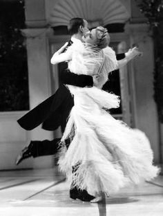 a man and woman dance together in an old fashion photo from the 1950's