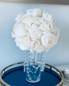 a bouquet of white flowers sitting on top of a blue tray