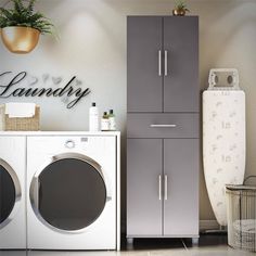 a washer and dryer sitting next to each other in front of a cabinet