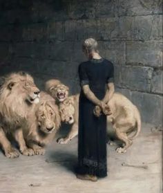 a woman standing in front of lions with their paws on her hips and two other lions behind her