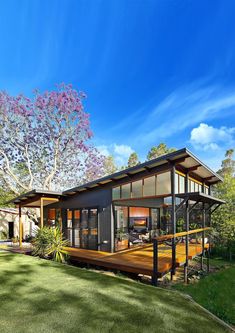 an artist's rendering of a modern house in the middle of a grassy area