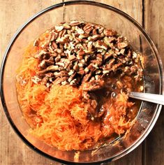 carrots and pecans in a bowl with grated cheese on the side, ready to be eaten