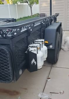 the back end of a truck with gas cans on it