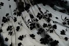 black flowers on white sheer fabric