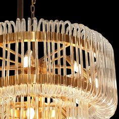 a chandelier made out of glass tubes and wood strips hanging from the ceiling