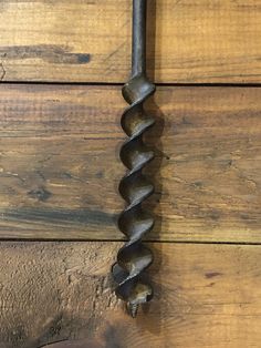 a close up of a metal object on a wooden surface