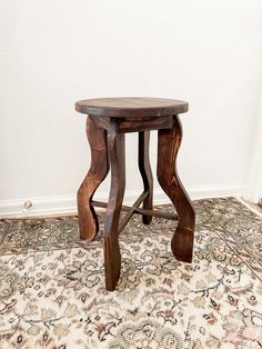 a small wooden table sitting on top of a rug