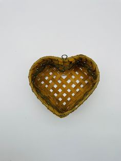 a heart shaped basket hanging on the wall