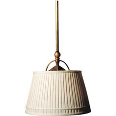 a white lamp hanging from the ceiling with a gold colored metal fixture on it's side