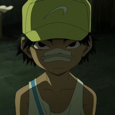 a person wearing a green hat and looking at the camera with an evil look on their face