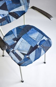 a chair made out of jeans with a metal arm rest