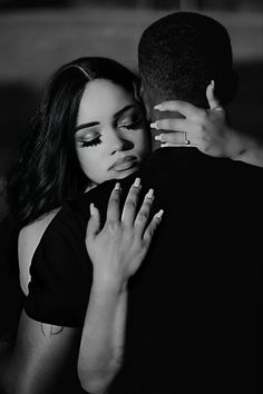 a couple embracing each other in black and white